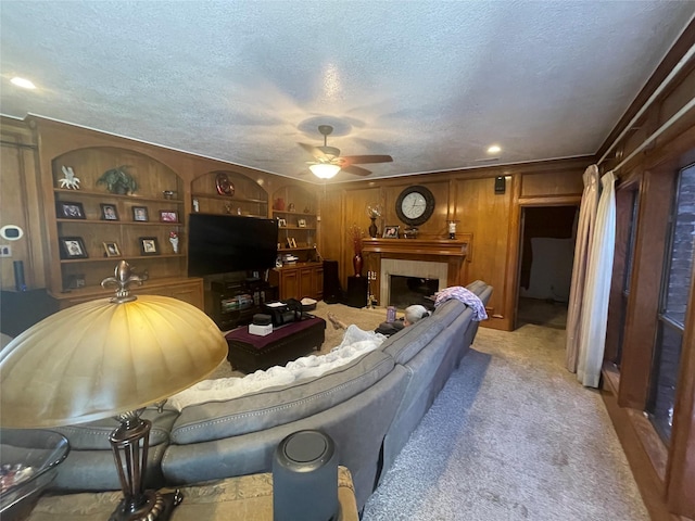 17518 Jackson Pnes, Houston, TX 77090 - living area featuring a ceiling fan, light carpet, a textured ceiling, and a fireplace