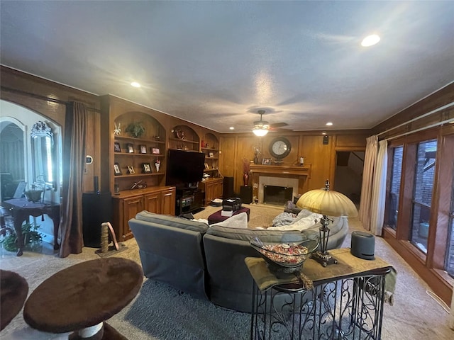 17518 Jackson Pnes, Houston, TX 77090 - living area featuring light carpet, a ceiling fan, a fireplace with raised hearth, recessed lighting, and built in shelves