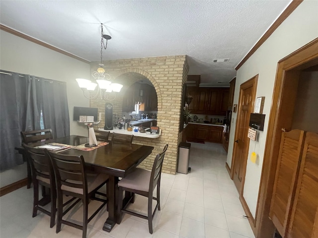 17518 Jackson Pnes, Houston, TX 77090 - dining area featuring ornamental molding, a textured ceiling, a chandelier, and arched walkways