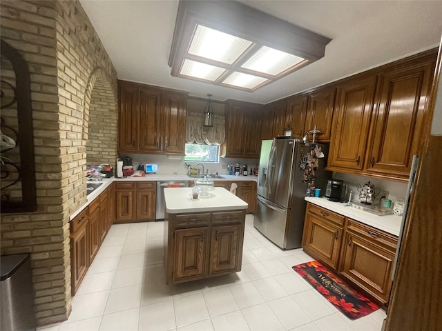 17518 Jackson Pnes, Houston, TX 77090 - kitchen with stainless steel appliances, a sink, light countertops, brick wall, and light tile patterned flooring