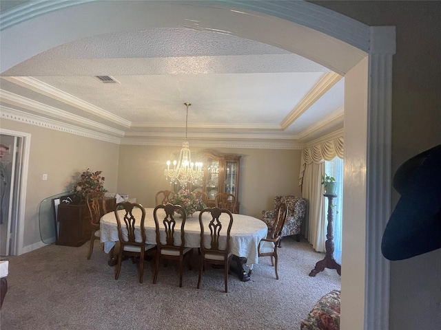 17518 Jackson Pnes, Houston, TX 77090 - dining space featuring a raised ceiling, carpet, crown molding, a chandelier, and arched walkways