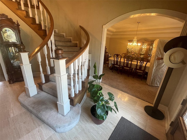 17518 Jackson Pnes, Houston, TX 77090 - staircase with crown molding, a chandelier, and arched walkways