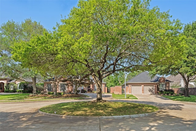 1107 Walden Hill Ct, Houston, TX 77077 - obstructed view of property featuring curved driveway, a garage, and brick siding