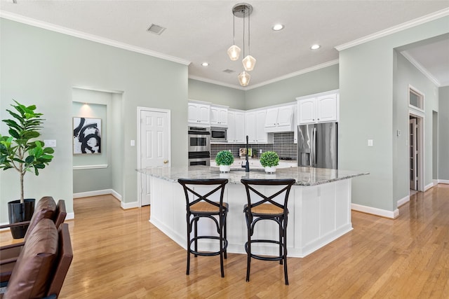 1107 Walden Hill Ct, Houston, TX 77077 - kitchen featuring appliances with stainless steel finishes, white cabinetry, tasteful backsplash, baseboards, and ornamental molding