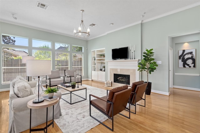1107 Walden Hill Ct, Houston, TX 77077 - living room with baseboards, light wood-style flooring, built in features, a chandelier, and crown molding