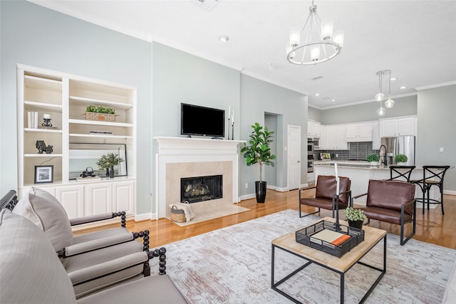 1107 Walden Hill Ct, Houston, TX 77077 - living area with a chandelier, light wood-type flooring, recessed lighting, crown molding, and a tile fireplace