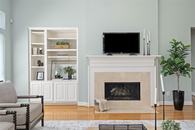 1107 Walden Hill Ct, Houston, TX 77077 - living room with wood finished floors, baseboards, and a tiled fireplace