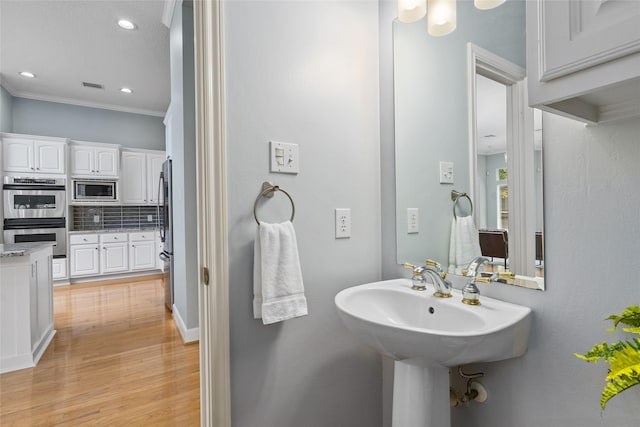 1107 Walden Hill Ct, Houston, TX 77077 - bathroom with tasteful backsplash, wood finished floors, crown molding, and recessed lighting