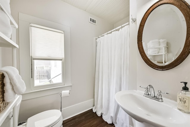 612 S Day St, Brenham, TX 77833 - bathroom featuring a sink, wood finished floors, toilet, and curtained shower