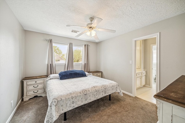 15314 Ripplewind Ln, Houston, TX 77068 - bedroom featuring light colored carpet, a textured ceiling, baseboards, ceiling fan, and ensuite bath