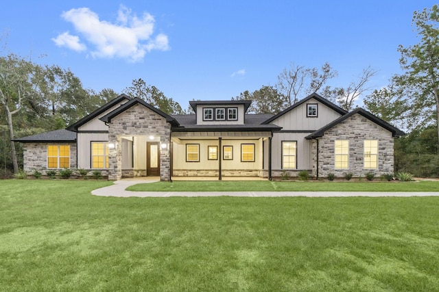 28200 E Stallion Ln, Waller, TX 77484 - view of front of property featuring stone siding, a front lawn, board and batten siding, and covered porch