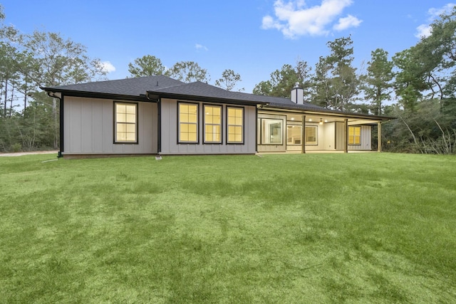 28200 E Stallion Ln, Waller, TX 77484 - rear view of property with a chimney, a lawn, and board and batten siding