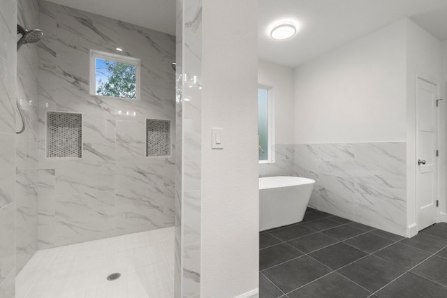 28200 E Stallion Ln, Waller, TX 77484 - bathroom featuring tile walls, a marble finish shower, a soaking tub, wainscoting, and tile patterned floors