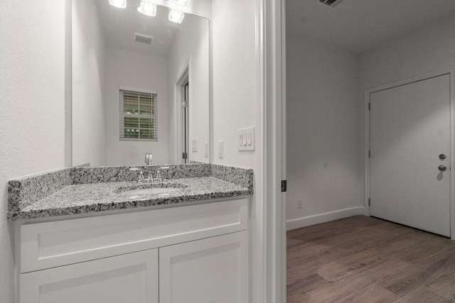 28200 E Stallion Ln, Waller, TX 77484 - bathroom featuring wood finished floors, vanity, and baseboards