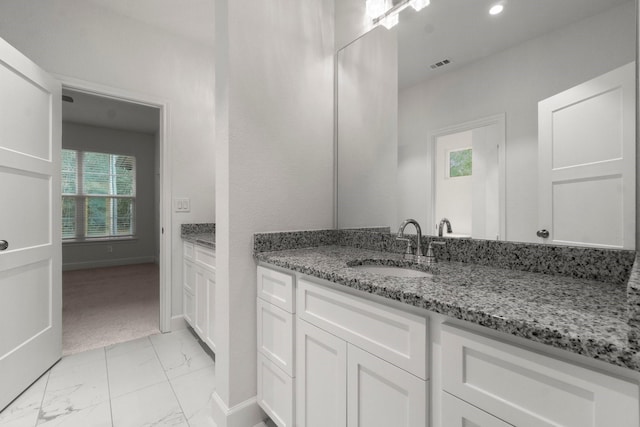 28200 E Stallion Ln, Waller, TX 77484 - bathroom featuring marble look tiles, vanity, baseboards, and recessed lighting