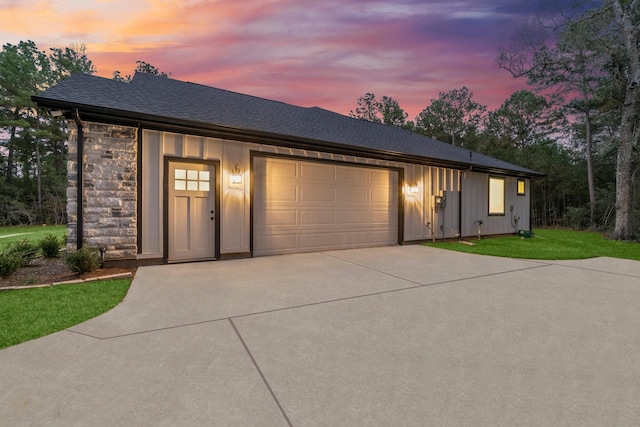 28200 E Stallion Ln, Waller, TX 77484 - view of front of property featuring board and batten siding, concrete driveway, a garage, a lawn, and roof with shingles