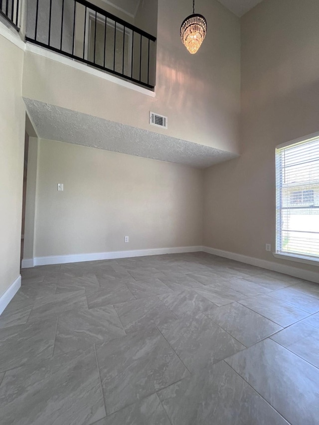 8330 Blue Quail Dr, Houston, TX 77489 - spare room with a high ceiling, baseboards, and a chandelier