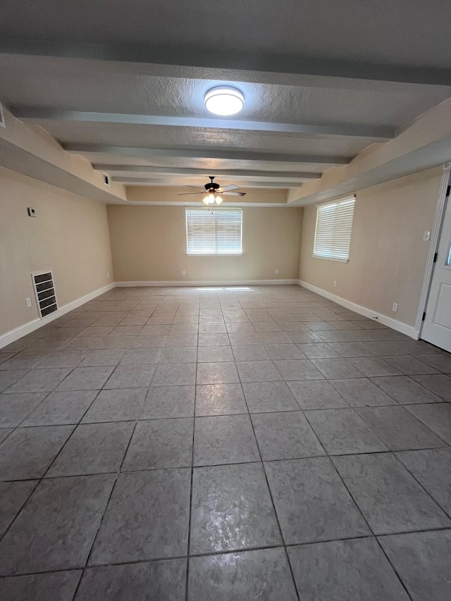 8330 Blue Quail Dr, Houston, TX 77489 - unfurnished room with tile patterned flooring, ceiling fan, beamed ceiling, baseboards, and a textured ceiling