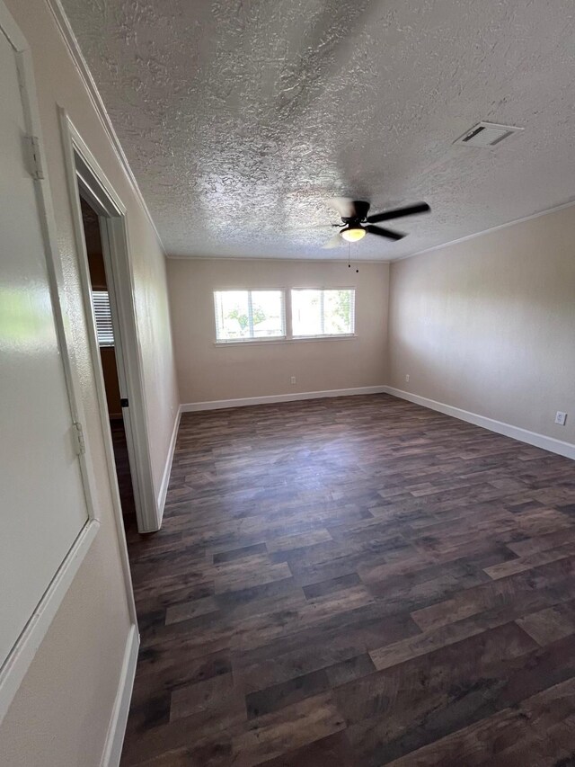 8330 Blue Quail Dr, Houston, TX 77489 - empty room featuring dark wood-type flooring, ceiling fan, a textured ceiling, baseboards, and ornamental molding