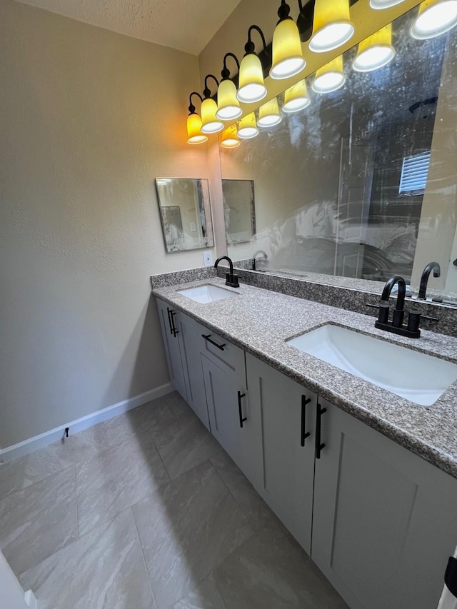 8330 Blue Quail Dr, Houston, TX 77489 - full bathroom with baseboards, double vanity, and a shower