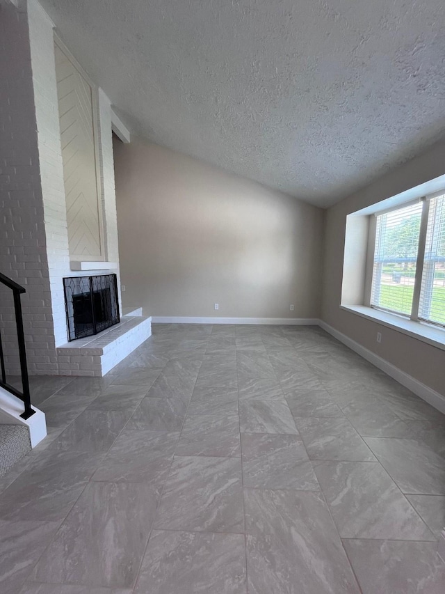 8330 Blue Quail Dr, Houston, TX 77489 - unfurnished living room with a textured ceiling, a fireplace, and baseboards