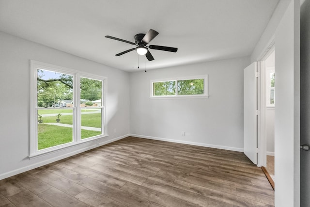 606 Clayton St, Tomball, TX 77375 - unfurnished room with dark wood finished floors, baseboards, and ceiling fan