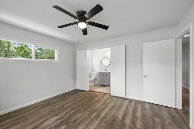 606 Clayton St, Tomball, TX 77375 - unfurnished bedroom featuring wood finished floors, connected bathroom, baseboards, a ceiling fan, and a sink