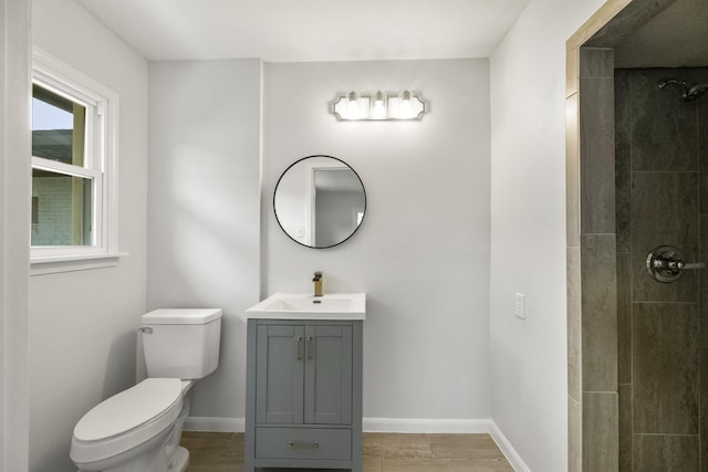 606 Clayton St, Tomball, TX 77375 - bathroom featuring toilet, baseboards, vanity, and a tile shower