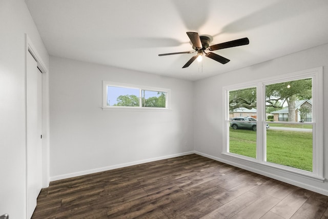 606 Clayton St, Tomball, TX 77375 - unfurnished bedroom featuring multiple windows, dark wood-style floors, and baseboards