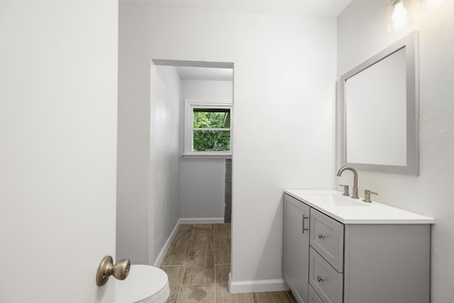 606 Clayton St, Tomball, TX 77375 - half bath with vanity, baseboards, and toilet