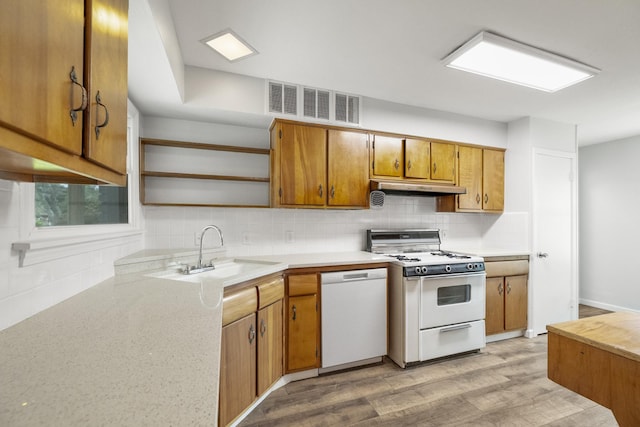 606 Clayton St, Tomball, TX 77375 - kitchen featuring white appliances, a sink, open shelves, under cabinet range hood, and light wood-style floors