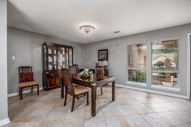 3706 Autumn Ln, Baytown, TX 77521 - dining room featuring a textured ceiling and baseboards