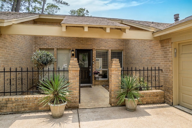 3706 Autumn Ln, Baytown, TX 77521 - doorway to property featuring brick siding and roof with shingles