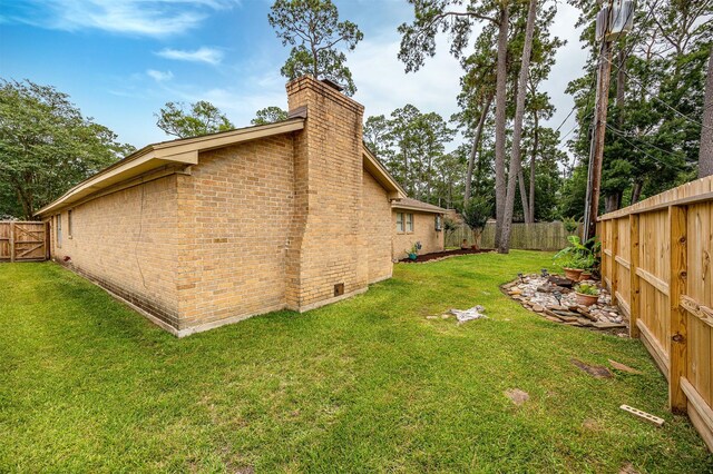 3706 Autumn Ln, Baytown, TX 77521 - view of side of property featuring a chimney and brick siding