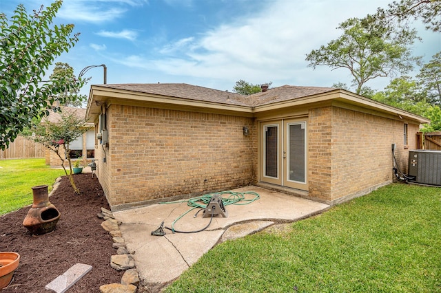 3706 Autumn Ln, Baytown, TX 77521 - back of house featuring a patio, brick siding, and central AC