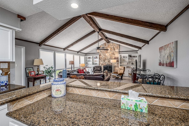 3706 Autumn Ln, Baytown, TX 77521 - living room with a fireplace, a ceiling fan, a textured ceiling, and built in features