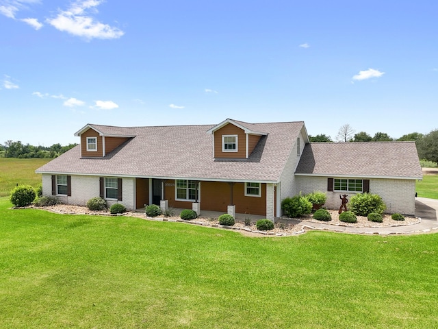 14624 Dove Ln, Needville, TX 77461 - cape cod-style house featuring brick siding, a shingled roof, and a front lawn
