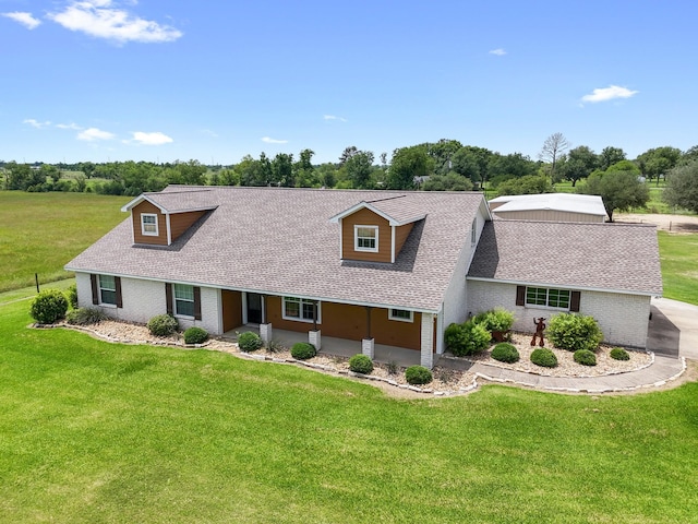 14624 Dove Ln, Needville, TX 77461 - view of front of property featuring a front yard, a shingled roof, brick siding, and view of scattered trees