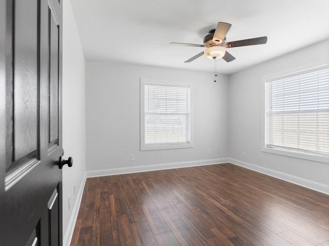 14624 Dove Ln, Needville, TX 77461 - empty room featuring dark wood-type flooring, ceiling fan, and baseboards