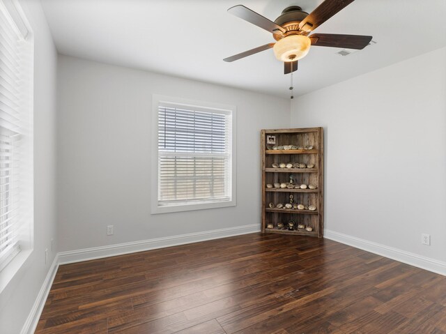 14624 Dove Ln, Needville, TX 77461 - empty room featuring wood finished floors, a ceiling fan, and baseboards