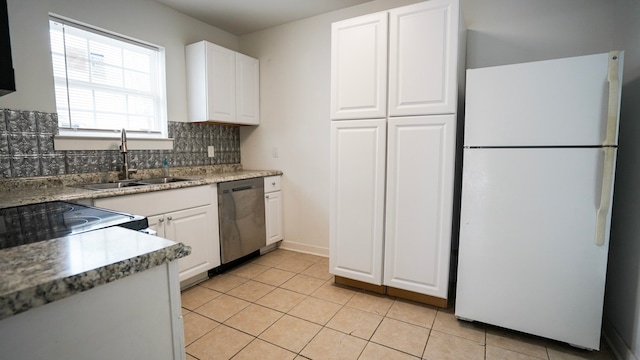 1126 Ryon St, Houston, TX 77009 - kitchen featuring freestanding refrigerator, stainless steel dishwasher, backsplash, and white cabinetry