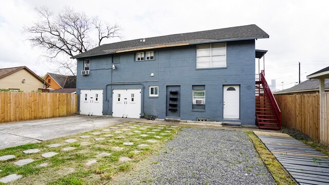 1126 Ryon St, Houston, TX 77009 - back of house with stairs, a shingled roof, and cooling unit