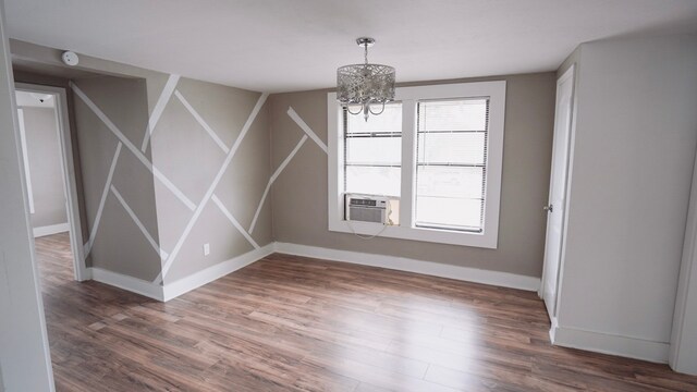 1126 Ryon St, Houston, TX 77009 - unfurnished dining area with wood finished floors, baseboards, and a chandelier