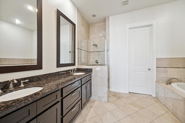5714 Kansas St, Houston, TX 77007 - full bathroom with a tile shower, double vanity, a bath, and tile patterned floors