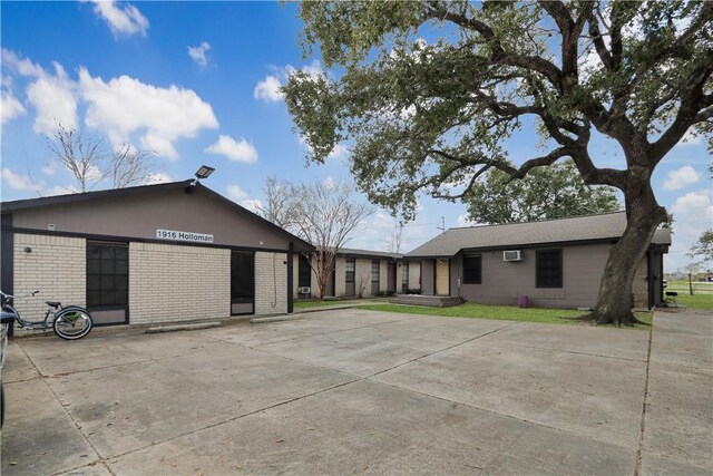 1916 Holloman Dr, Port Lavaca, TX 77979 - view of front of property featuring brick siding and a wall mounted air conditioner