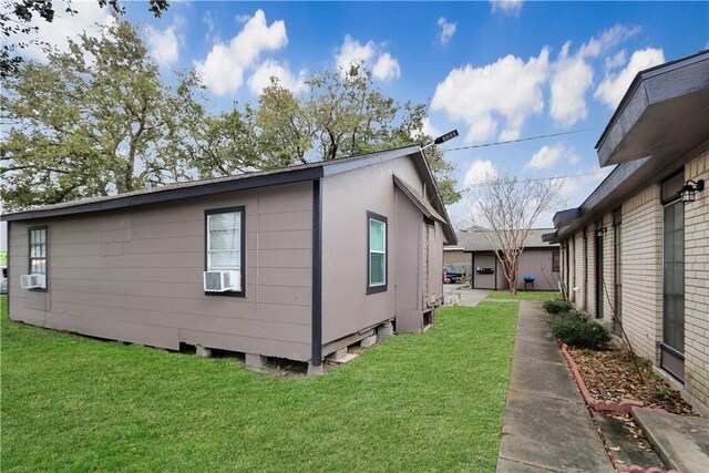 1916 Holloman Dr, Port Lavaca, TX 77979 - view of side of home featuring a yard and cooling unit