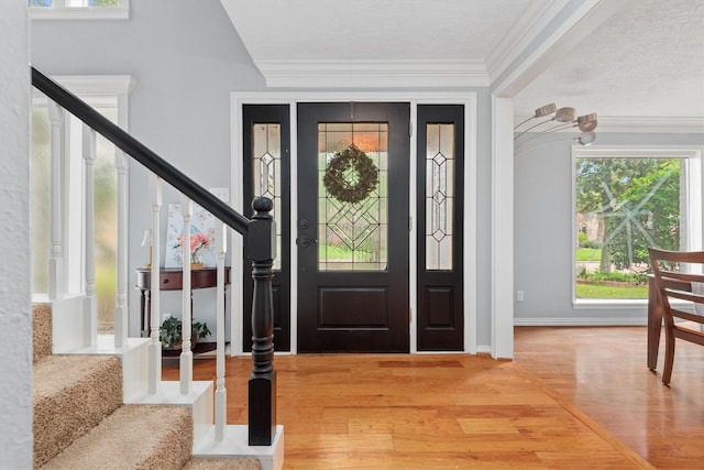 11723 Quail Creek Dr, Houston, TX 77070 - foyer featuring stairway, light wood-style flooring, ornamental molding, baseboards, and a textured ceiling