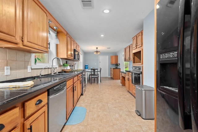 11723 Quail Creek Dr, Houston, TX 77070 - kitchen featuring black appliances, a sink, decorative backsplash, recessed lighting, and brown cabinets