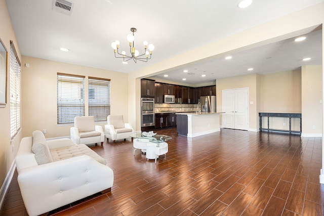4911 Lattimore Creek Dr, Houston, TX 77084 - living room featuring a chandelier, baseboards, dark wood-type flooring, and recessed lighting