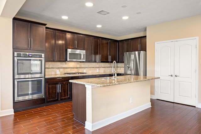 4911 Lattimore Creek Dr, Houston, TX 77084 - kitchen featuring stainless steel appliances, dark wood finished floors, a sink, decorative backsplash, and recessed lighting